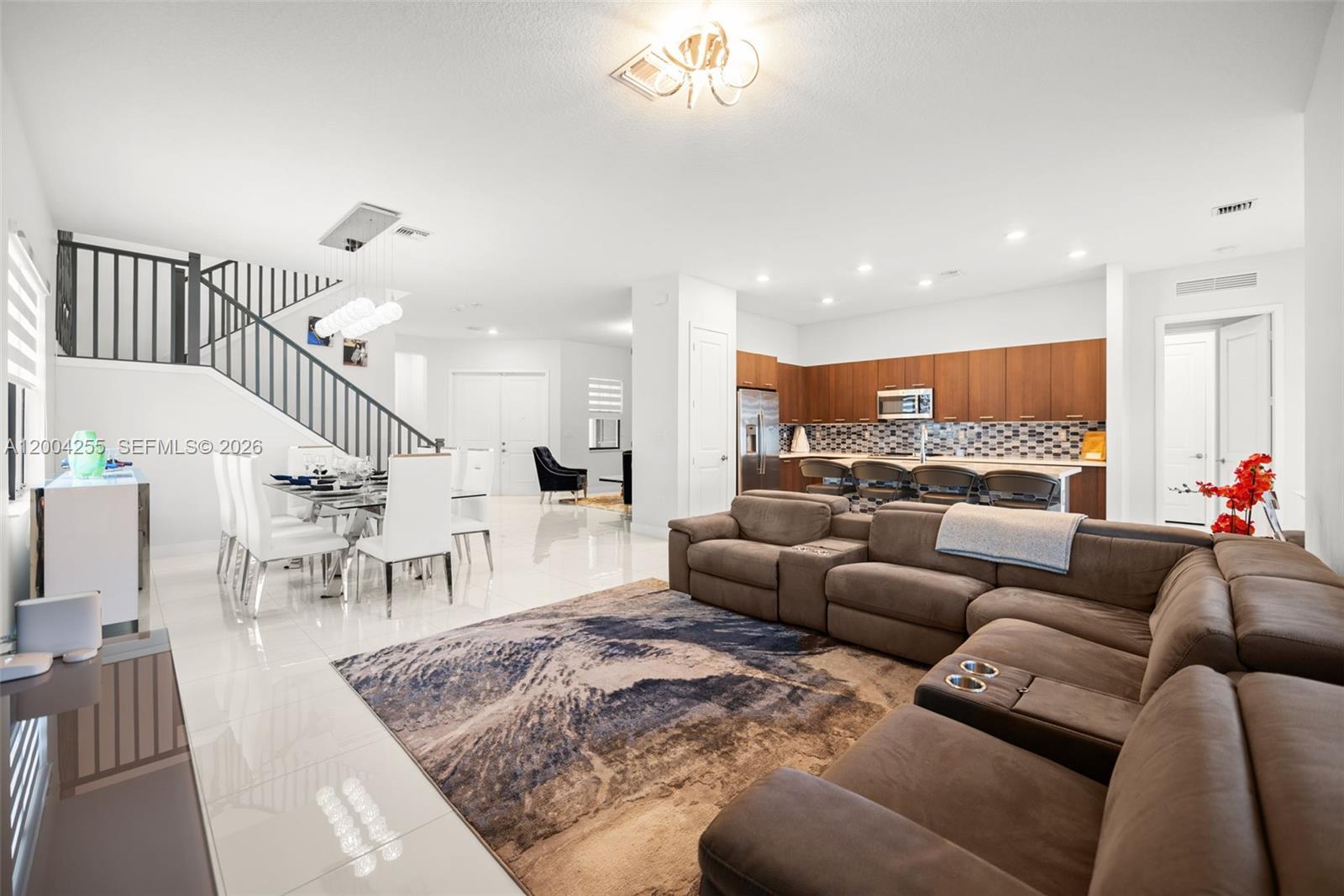 An open-concept living area features a kitchen, dining space, and sectional sofa on tile floors — 4366 SW 174th Ave, Miramar FL 33029, MIRAMAR, FL