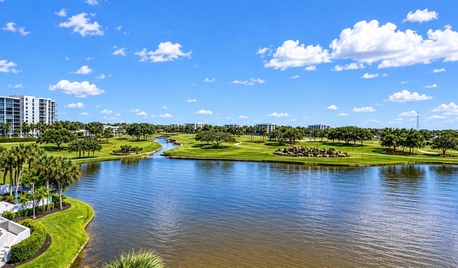 An elevated view of a lake surrounded by a golf course and residential buildings — 7768 Lakeside Boulevard # 551, Boca Raton FL 33434, BOCA RATON, FL