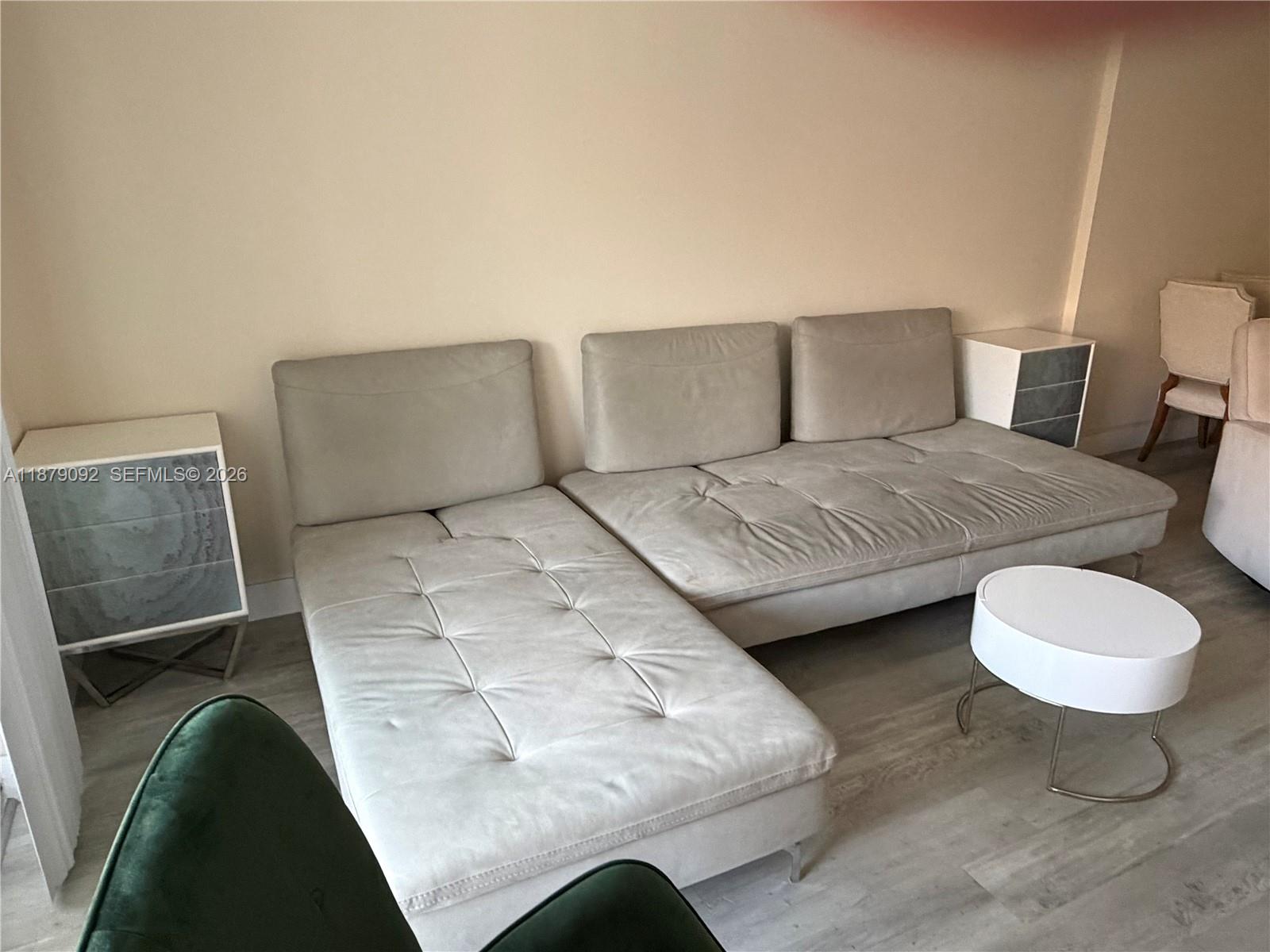 A light-colored sectional sofa sits in a room with light wood-look flooring — 901 NE 14th Ave # 305, Hallandale Beach FL 33009, HALLANDALE BEACH, FL
