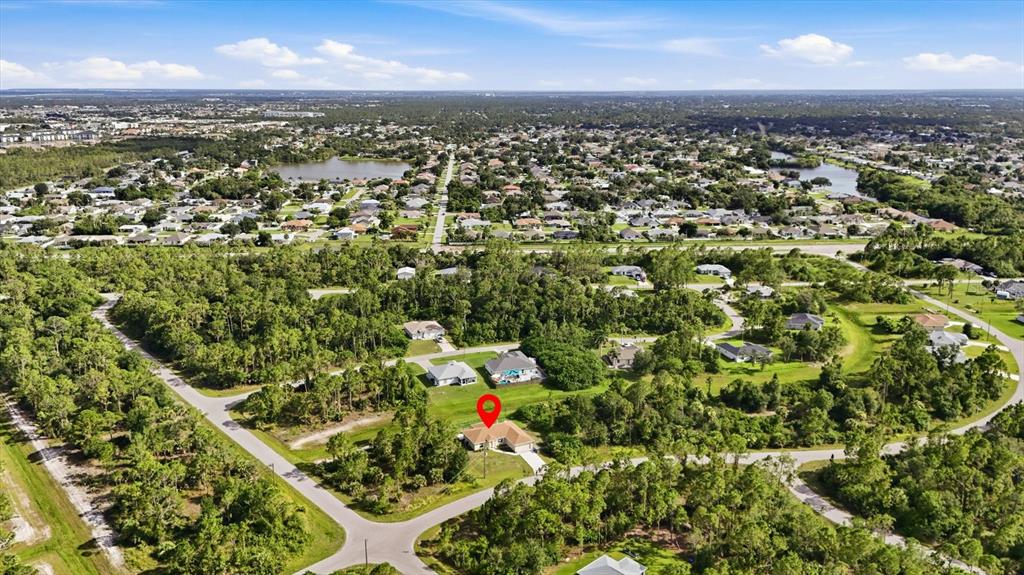 An aerial view shows a single-family home with a red location pin in a neighborhood — 1458 RICHBRIAR DRIVE, NORTH PORT, FL