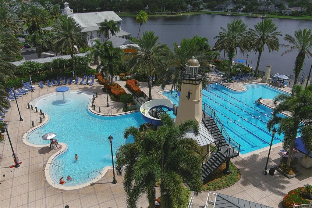 An aerial view of a community pool area featuring a lighthouse slide and lap lanes — 724 WINTERSIDE DRIVE, APOLLO BEACH, FL
