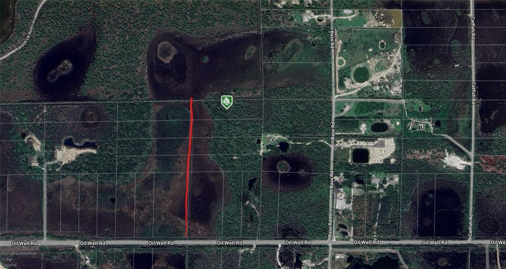 An aerial map shows a red line marking a property boundary near Oil Well Road — 31940 OIL WELL ROAD, PUNTA GORDA, FL