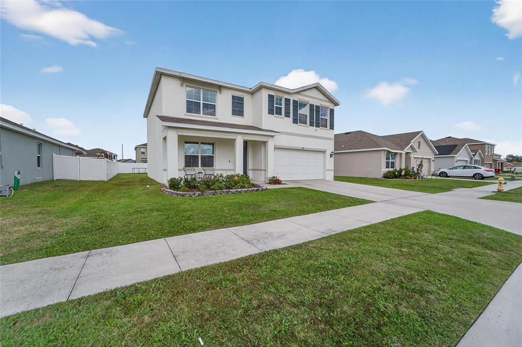A two-story suburban house with a white exterior, a front porch, and a two-car garage — 3009 BLAKERT COURT, PLANT CITY, FL