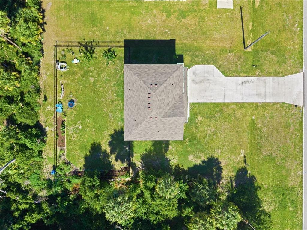An aerial view shows a house with a hip roof, a concrete driveway, and a fenced yard — 2737 E PRICE BOULEVARD, NORTH PORT, FL