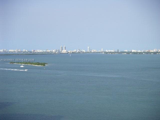An elevated view of a bay with a distant city skyline and a small island — 1750 N Bayshore Dr # 3907, Miami FL 33132, MIAMI, FL