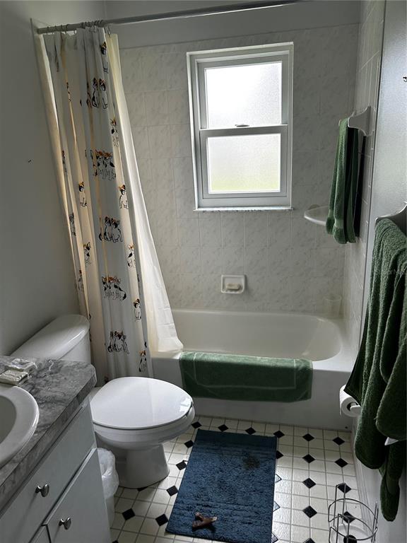 A bathroom features a white tub-shower combo, a toilet, and a vanity with a countertop — 1109 S CHATEAU POINT, INVERNESS, FL