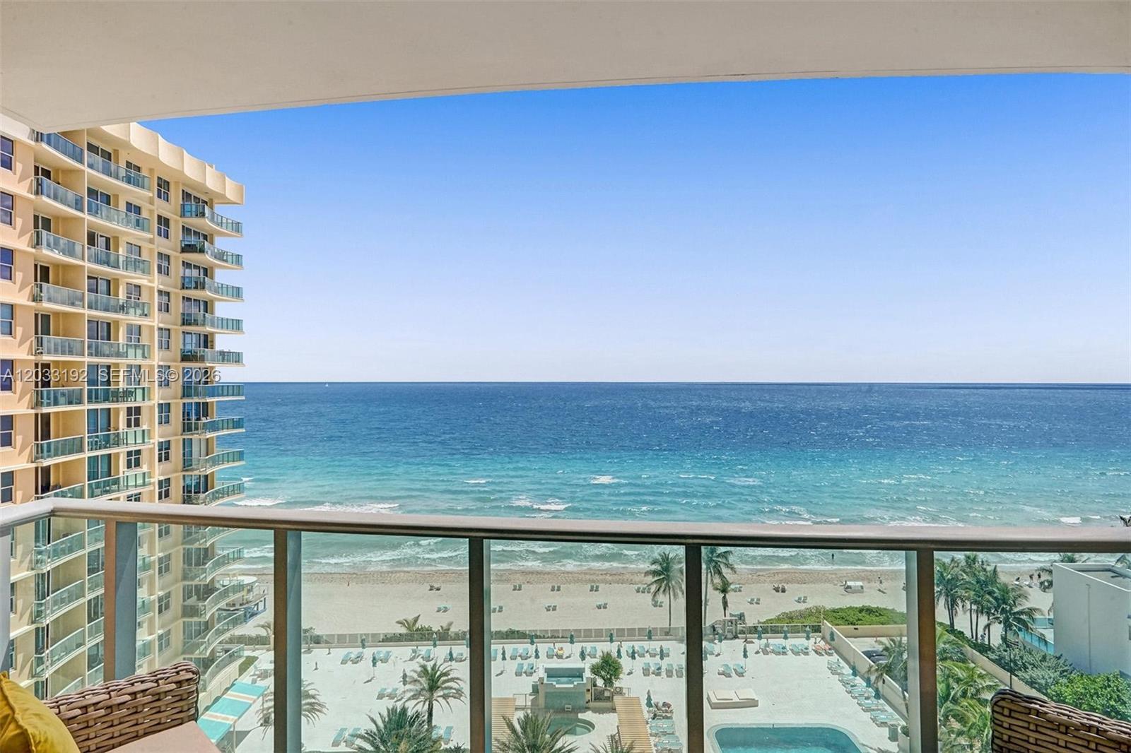 A balcony view overlooks a sandy beach, the ocean, and a neighboring high-rise building — 2501 S Ocean Dr, Hollywood FL 33019, HOLLYWOOD, FL