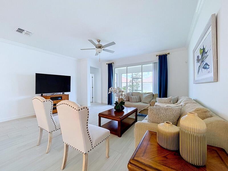 A living room features a beige sofa, two upholstered chairs, a coffee table, and a television — 17228 Star Banks Street, FL 33598, FL