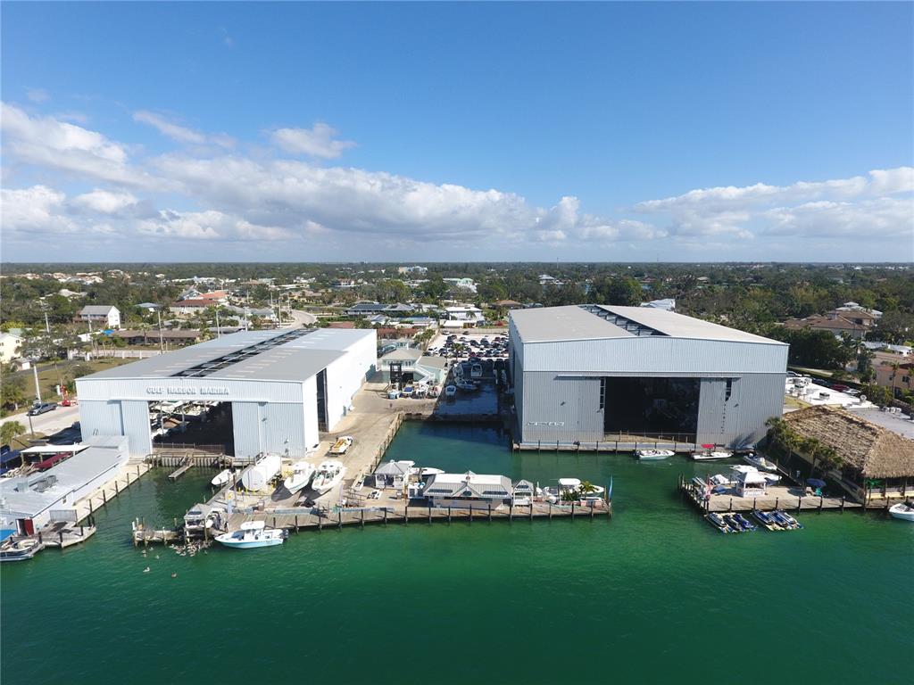 An aerial view shows two large metal warehouse buildings at a marina with docked boats — 100 CIRCUIT ROAD UNIT S71, NOKOMIS, FL