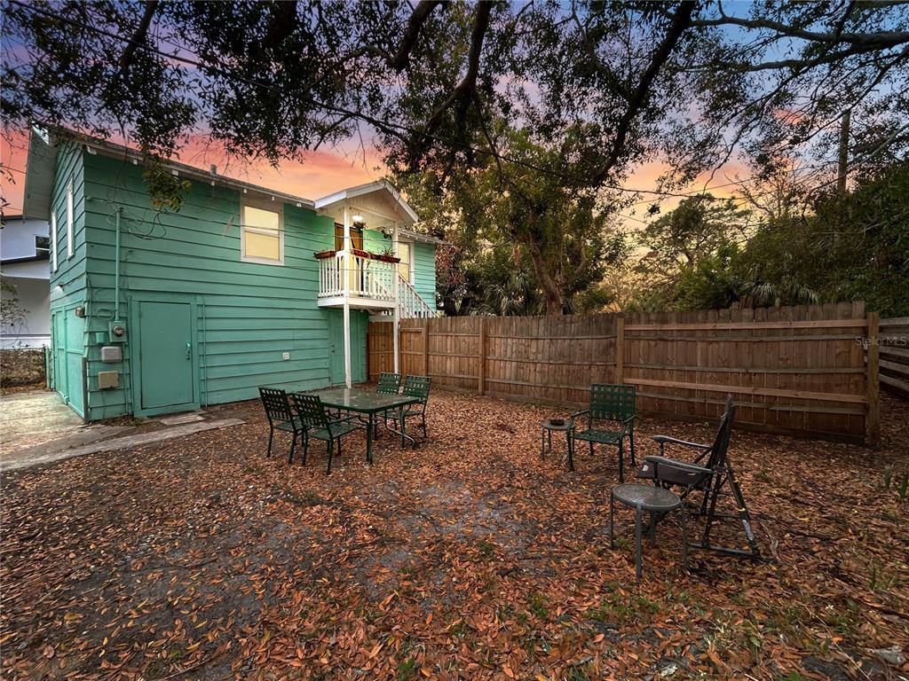 A teal two-story house with a yellow front door and a stone walkway — 626 37TH AVENUE S, ST PETERSBURG, FL