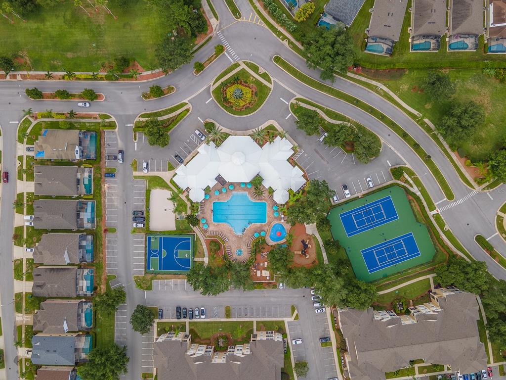 An aerial view shows a community clubhouse with a swimming pool, tennis courts, and parking — 8102 PRINCESS PALM LANE UNIT #305, KISSIMMEE, FL