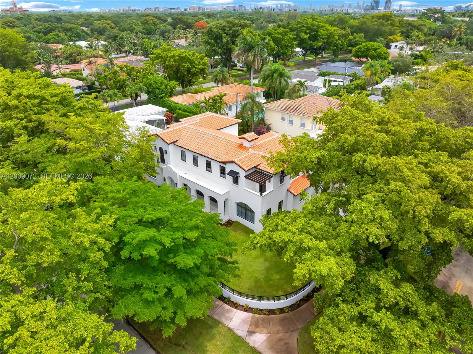 An aerial view shows a white two-story house with a terracotta tile roof — 5111 Alhambra Cir, Coral Gables FL 33146, CORAL GABLES, FL
