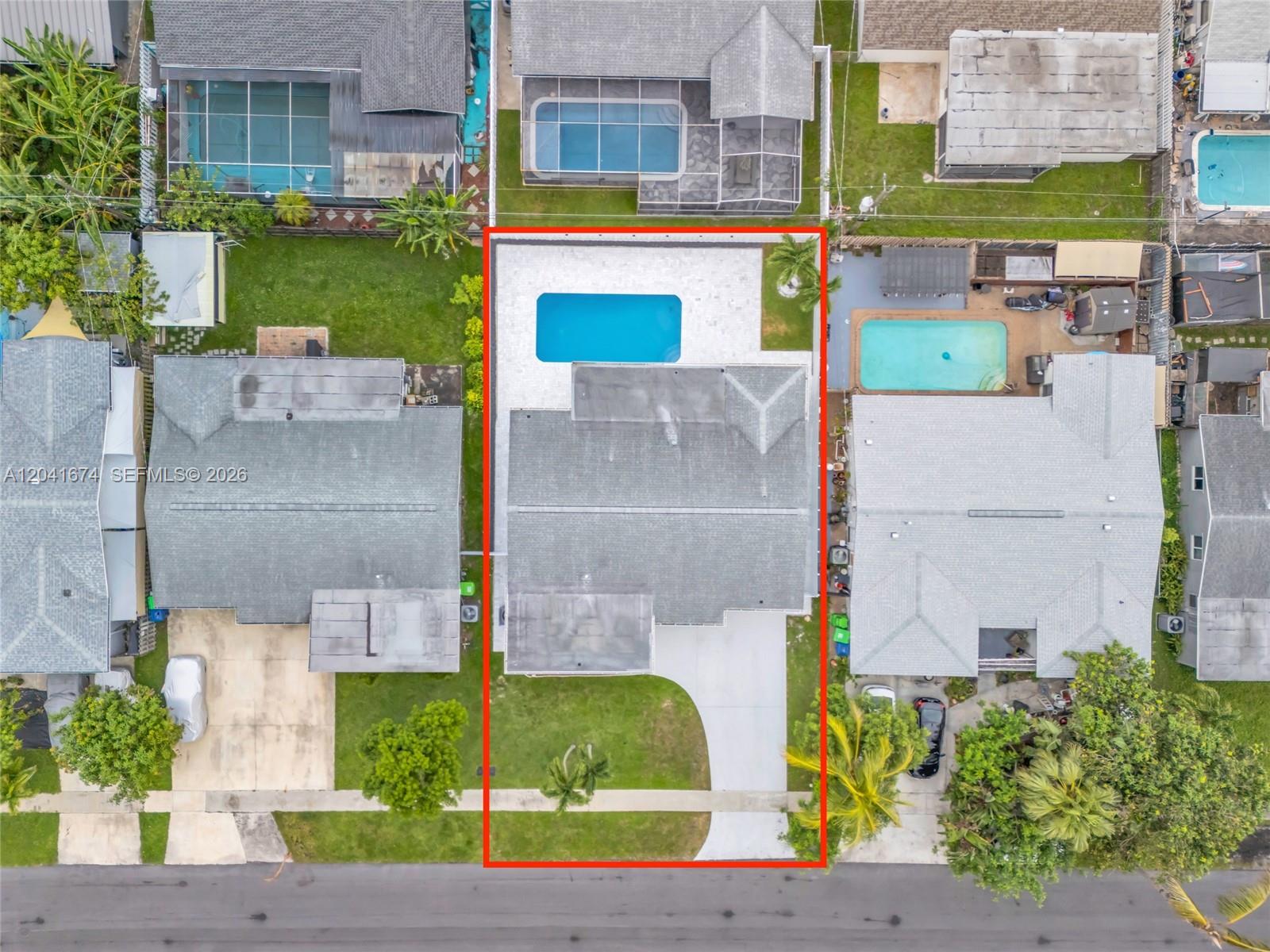 An aerial view shows a house with a swimming pool and a paved driveway — 8661 NW 20th Ct, Sunrise FL 33322, SUNRISE, FL