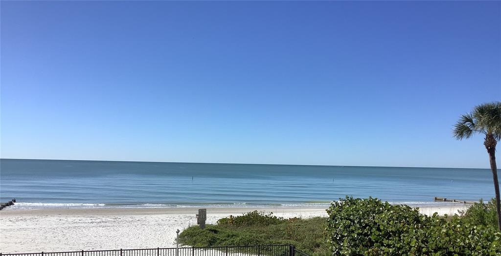 A view of a sandy beach and the ocean under a clear blue sky — 14900 GULF BOULEVARD UNIT 113, MADEIRA BEACH, FL