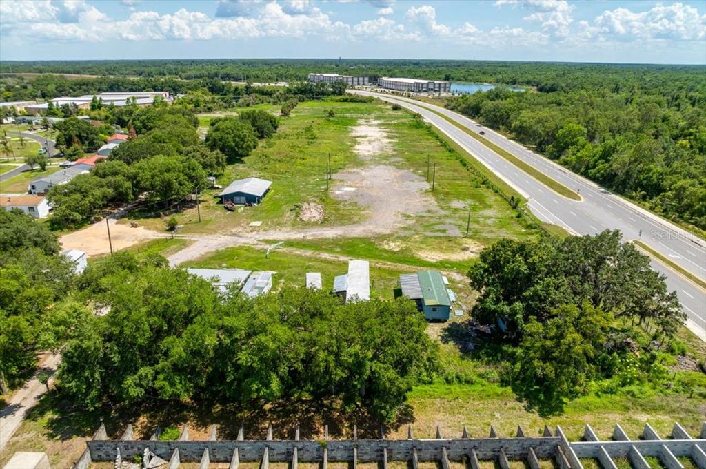 An aerial view shows a large, mostly vacant lot adjacent to a multi-lane highway — 4043 DANA KATHERINE DRIVE, KISSIMMEE, FL