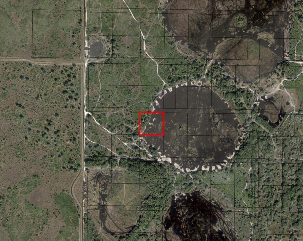 This is an aerial map showing a red square highlighting a parcel of land — 0 NW 302nd Street, Okeechobee FL 34972, OKEECHOBEE, FL