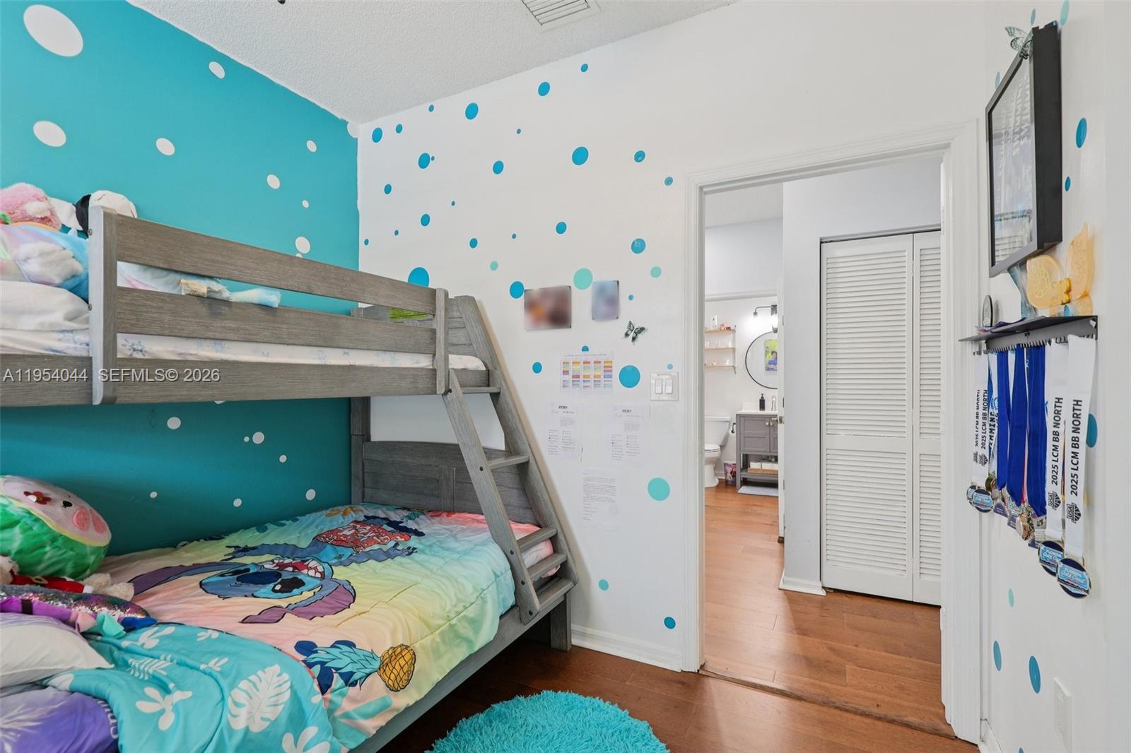 A bedroom features a bunk bed, polka-dot wall decals, and an open doorway to a bathroom — 2923 Crestwood Ter # 5104, Margate FL 33063, MARGATE, FL
