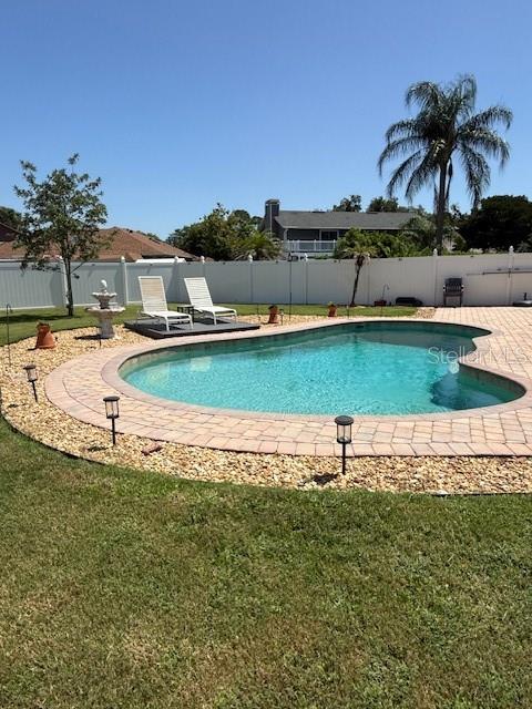 A single-story house with a solar panel roof, stone accents, and a manicured front lawn — 1010 PALADIN COURT, ORLANDO, FL