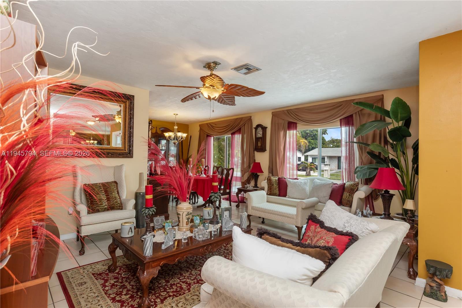 A living room with beige furniture, a wooden coffee table, and a red area rug — 15244 SW 108th Ct, Miami FL 33157, MIAMI, FL