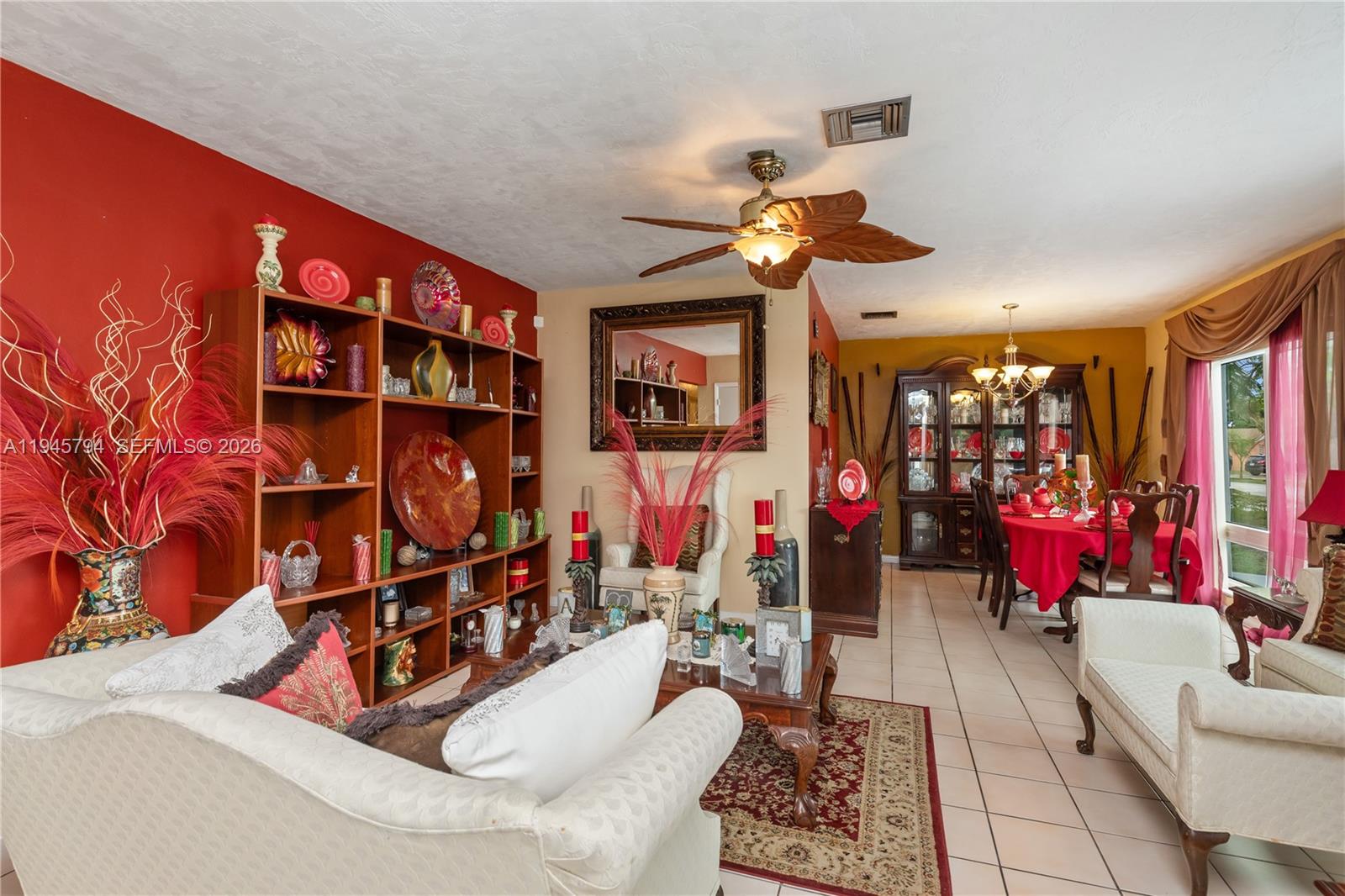 A living and dining room features red accent walls, tiled floors, and traditional furniture — 15244 SW 108th Ct, Miami FL 33157, MIAMI, FL