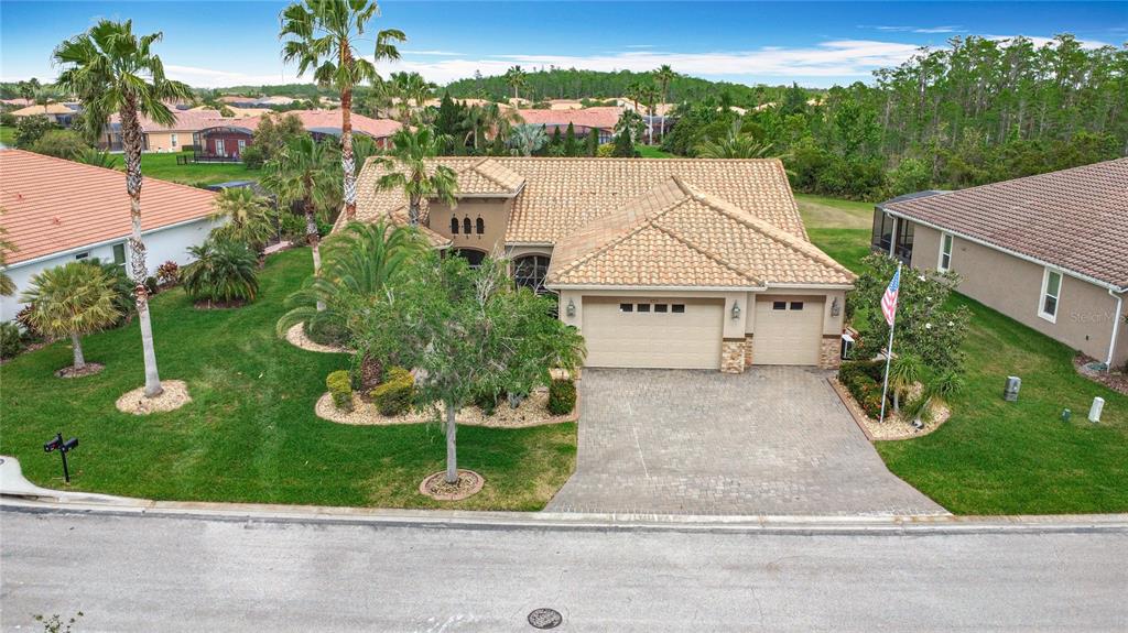 An aerial view of a single-story house with a tile roof and a paved driveway — 772 SAN RAPHAEL STREET, KISSIMMEE, FL
