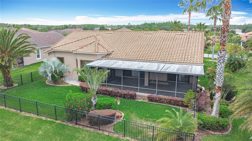 An aerial view of a house with a tiled roof and a screened-in back porch — 772 SAN RAPHAEL STREET, KISSIMMEE, FL