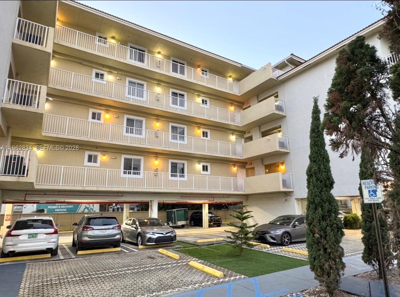 A multi-story apartment building with covered parking and a small landscaped area in front — 134 SW 7th Ave # 404, Miami FL 33130, MIAMI, FL