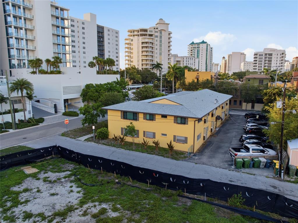 An aerial view shows a yellow two-story apartment building next to a parking lot — 615 S PALM AVENUE UNIT 10, SARASOTA, FL