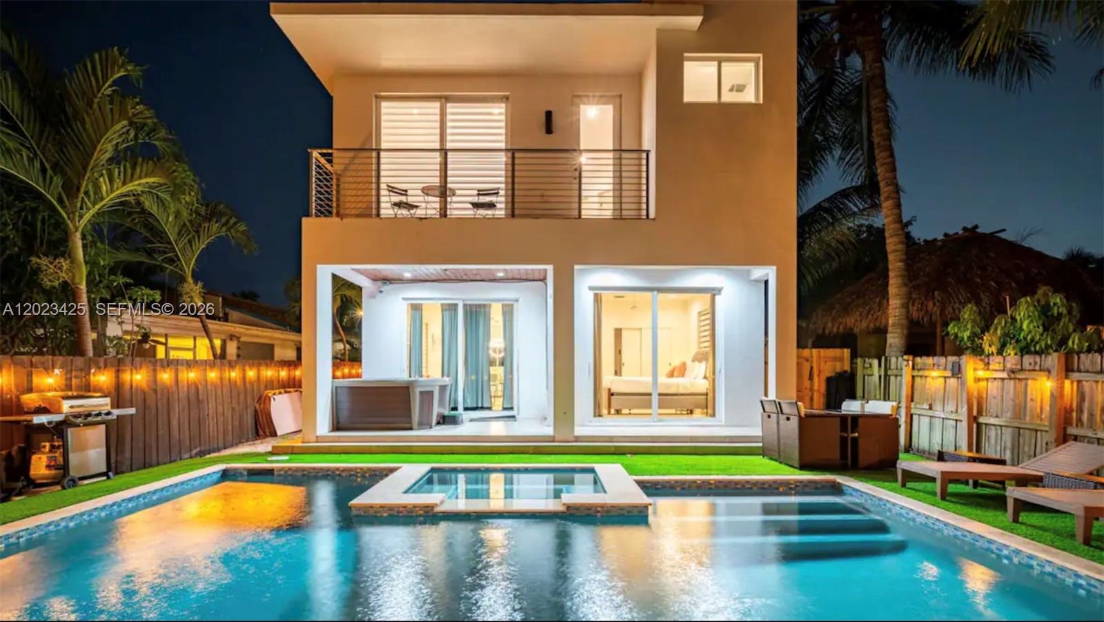 A two-story house exterior features a swimming pool, a hot tub, and a balcony — 1547 Jackson St, Hollywood FL 33020, HOLLYWOOD, FL