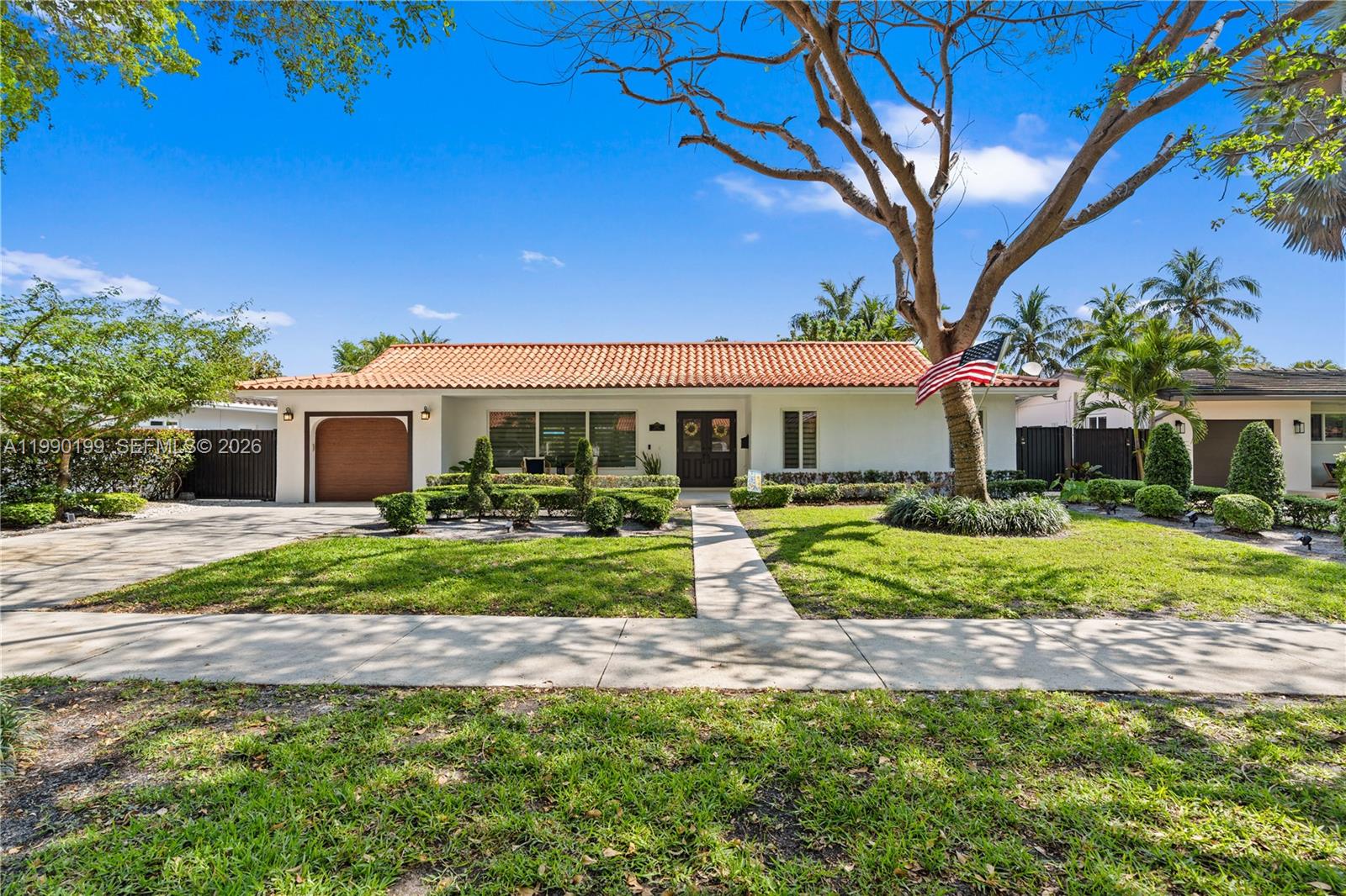 A patio with a swimming pool, bamboo dining furniture, and a white house exterior — 7327 Sabal Dr, Miami Lakes FL 33014, MIAMI LAKES, FL