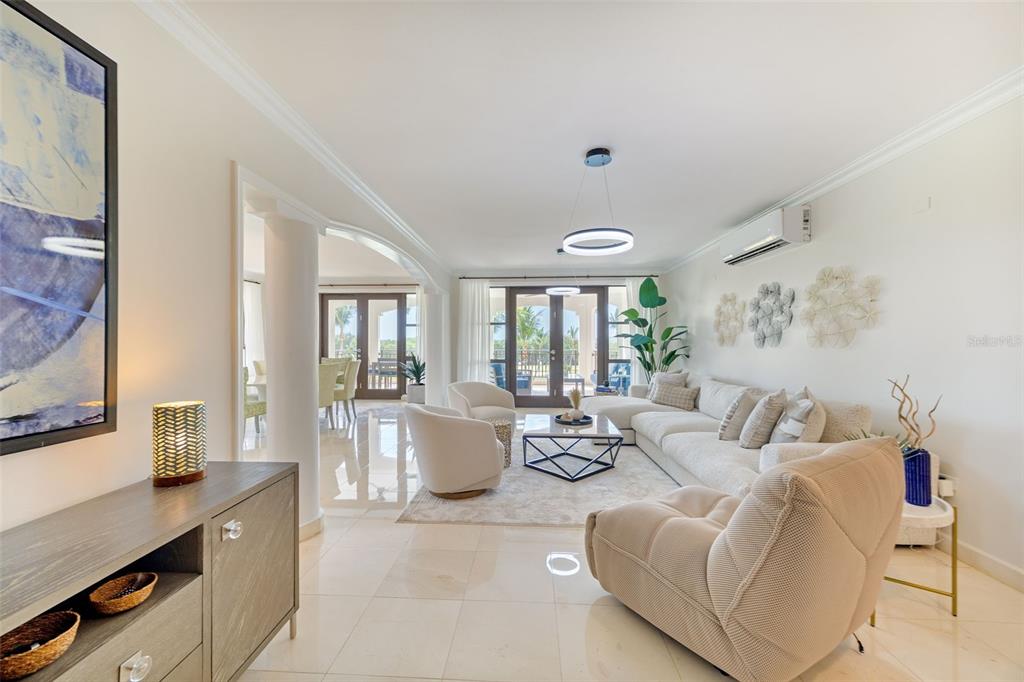 A bright living room features light tile floors, a sectional sofa, and a dining area — 400 COCO BEACH BOULEVARD UNIT G-301, RIO GRANDE, PR