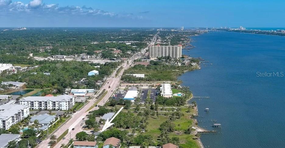 An aerial view shows a coastal road, residential buildings, and a large body of water — 108 MURRAY WAY UNIT 1, SOUTH DAYTONA, FL
