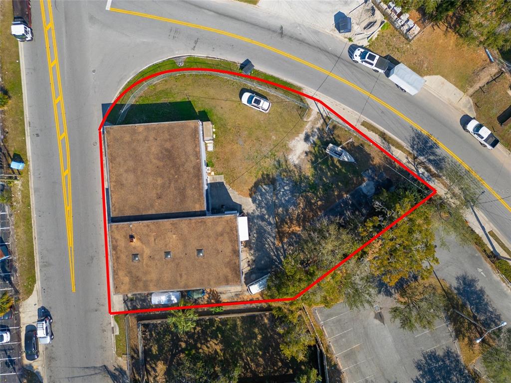An aerial view shows a commercial building on a corner lot outlined in red — 41 N DOLLINS AVENUE, ORLANDO, FL