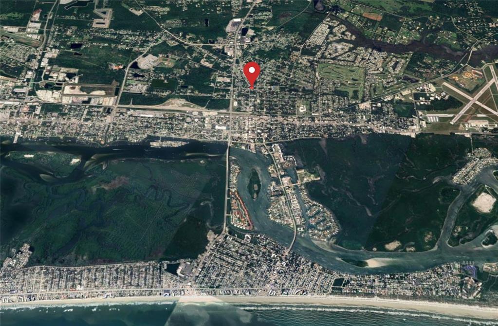 An aerial map view showing a coastal town with a red location pin — 907 CANAL STREET, NEW SMYRNA BEACH, FL