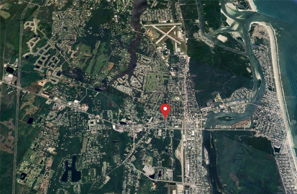 This is an aerial map view showing a red location pin over a residential area — 907 CANAL STREET, NEW SMYRNA BEACH, FL