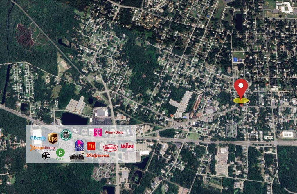 This is an aerial map showing a property location with nearby businesses and surrounding neighborhoods — 907 CANAL STREET, NEW SMYRNA BEACH, FL