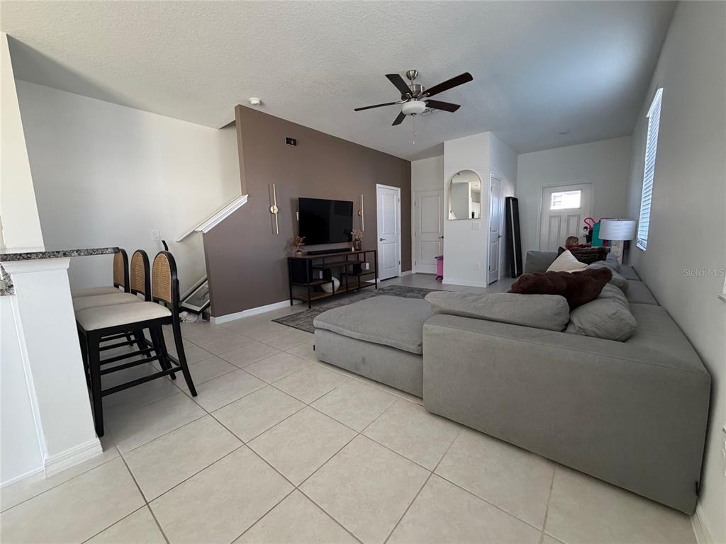 A dining area features a rectangular table, four upholstered chairs, a pendant light, and a plant — 10268 HONEY HAMMOCK WAY UNIT 10268, SAN ANTONIO, FL