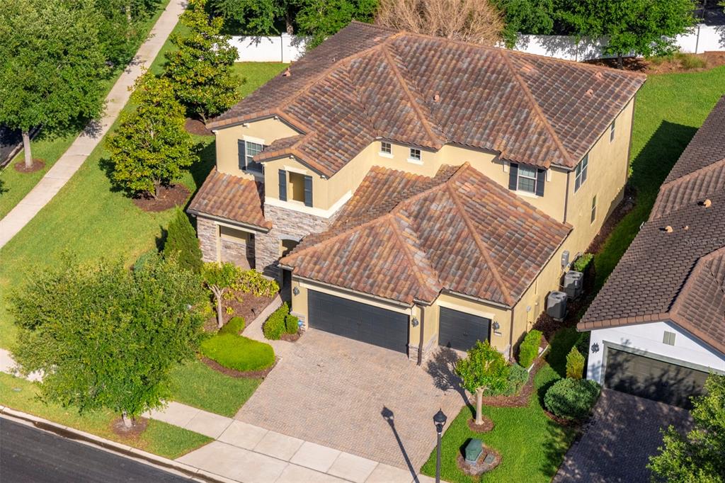 An aerial view of a two-story house with a tile roof and a paved driveway — 10950 CITRON OAKS DRIVE, ORLANDO, FL