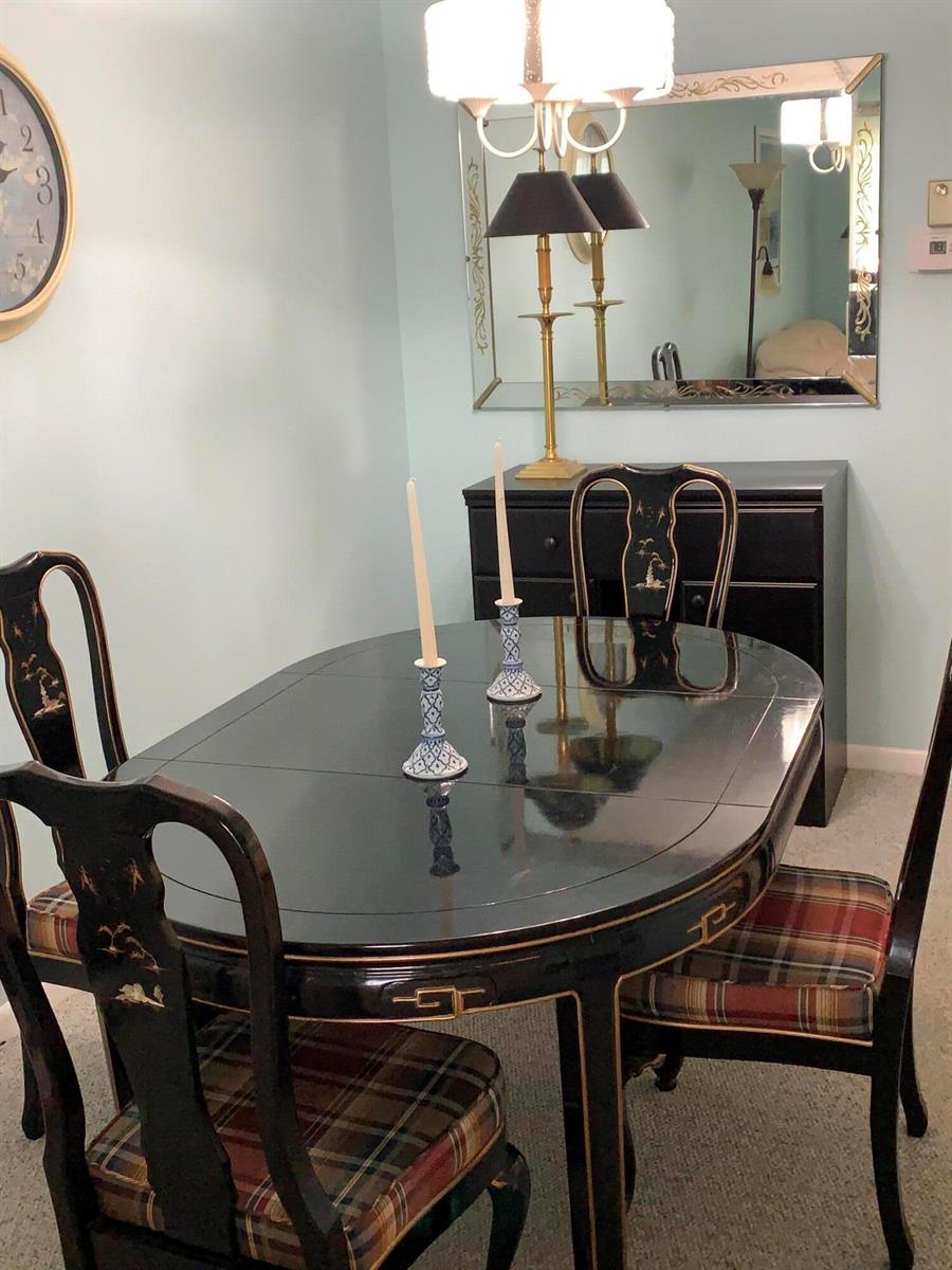 A dining room features a black lacquered table and chairs with plaid upholstered seats — 100 S South Boulevard # 1c, Boynton Beach FL 33435, BOYNTON BEACH, FL
