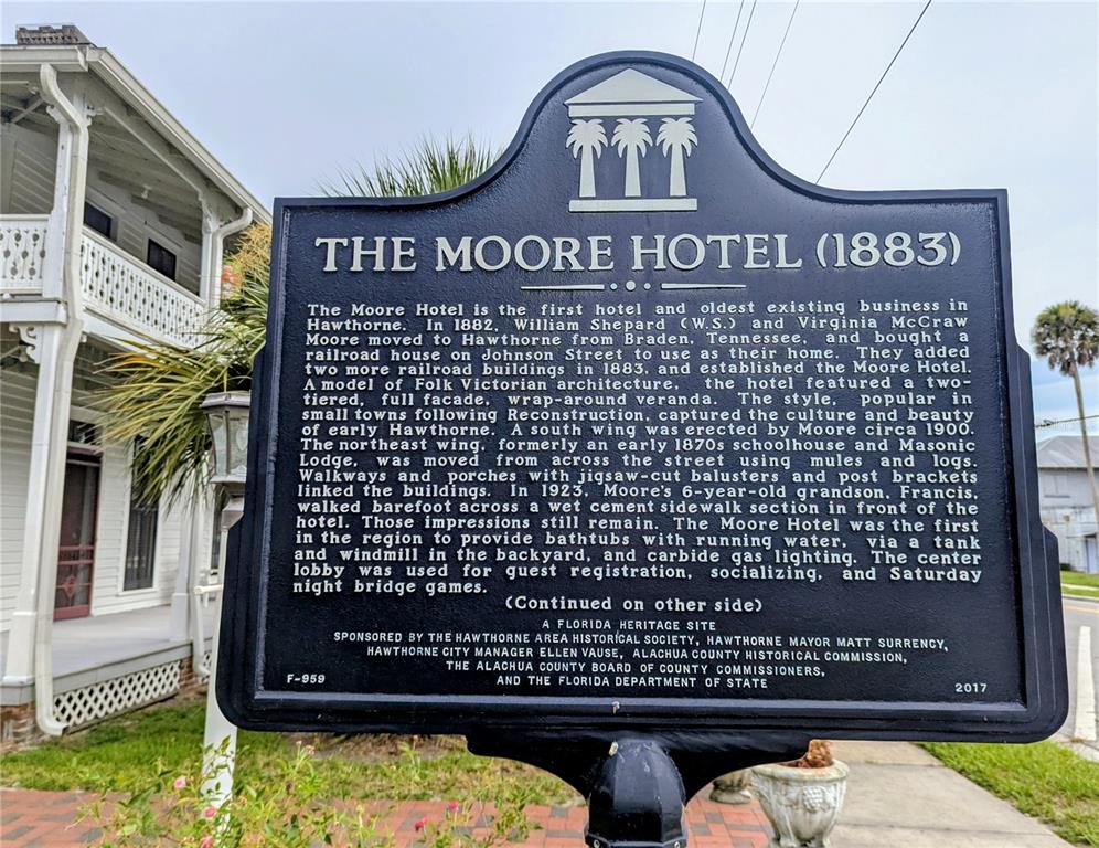 A historical marker for The Moore Hotel stands in front of a white Victorian building — 6635 SE 221ST STREET UNIT 3, HAWTHORNE, FL