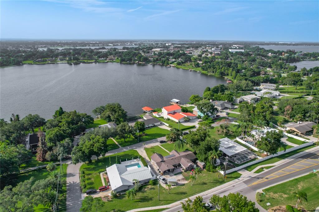 A single-story house with a brown exterior, solar panels, and a front patio — 128 N LAKE FLORENCE DRIVE, WINTER HAVEN, FL