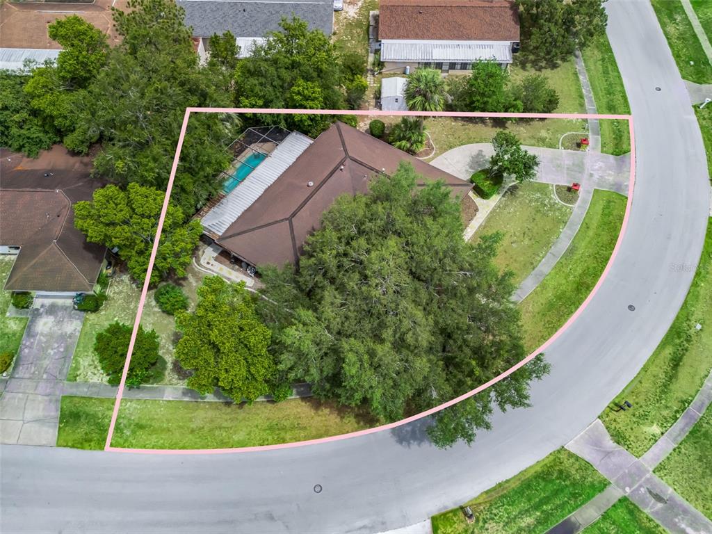 An aerial view shows a house with a pool and a large tree on a lot — 15090 SW 35TH CIRCLE, OCALA, FL