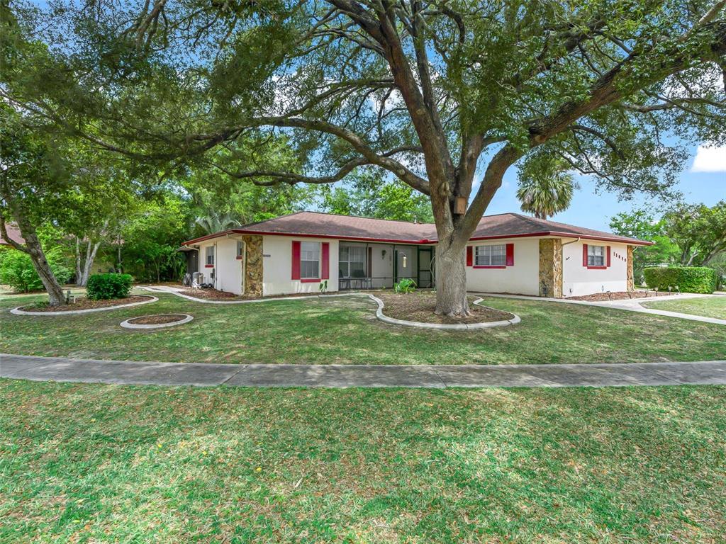 A single-story house with a large oak tree in the front yard — 15090 SW 35TH CIRCLE, OCALA, FL