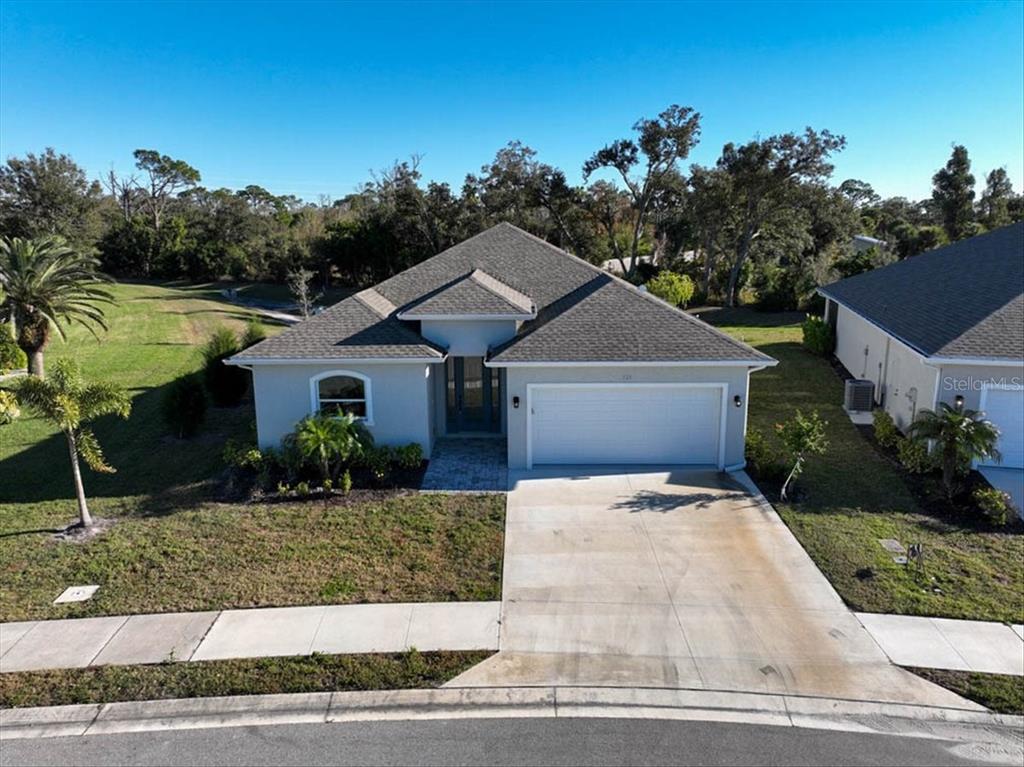 An aerial view of a single-story suburban house with a two-car garage and driveway — 725 REDBUD COURT, ENGLEWOOD, FL
