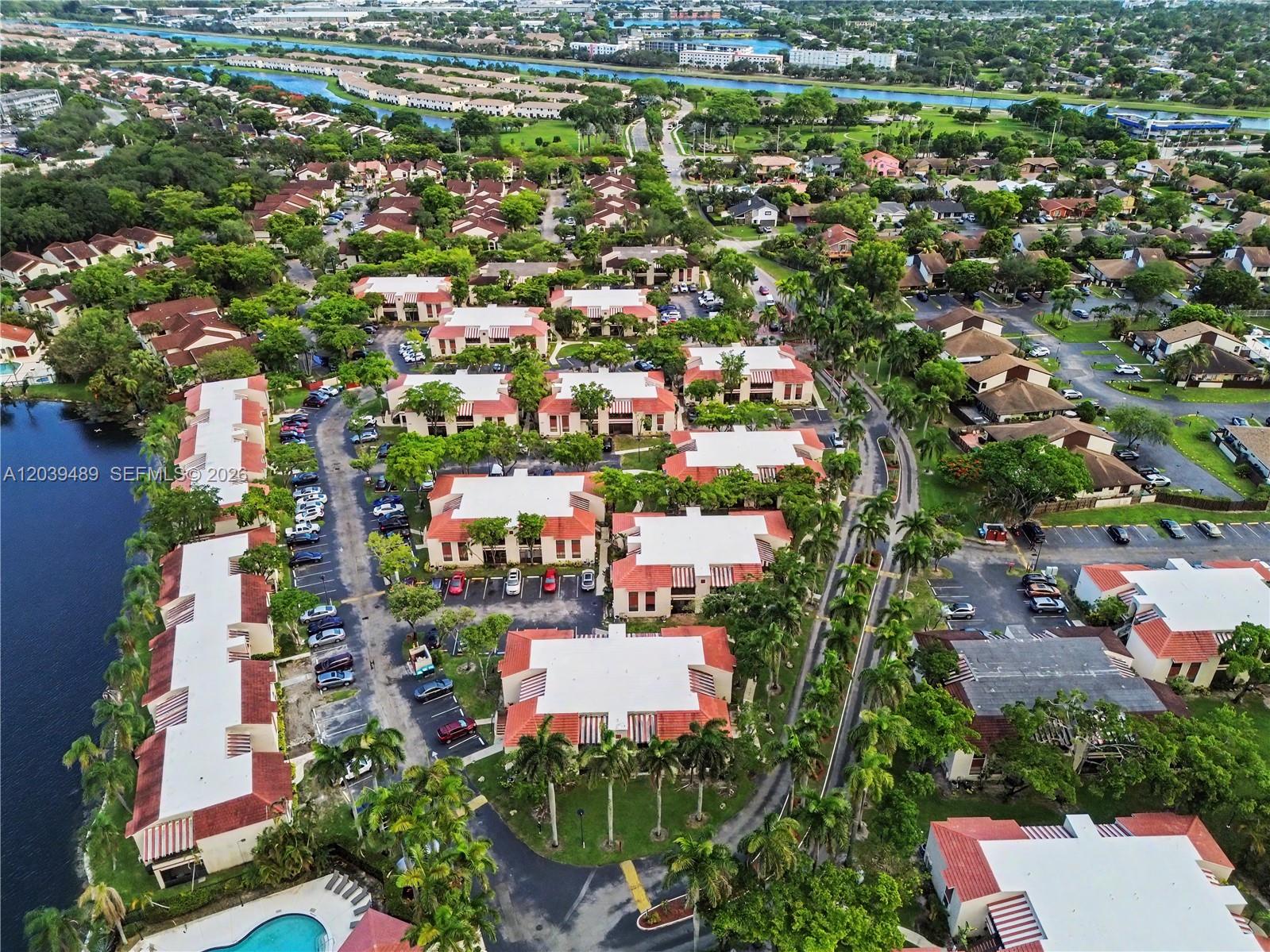 An aerial view shows a residential complex with multiple buildings, parking lots, and a pool — 3rd Ct 20135 # 1, Miami FL 33179, MIAMI, FL
