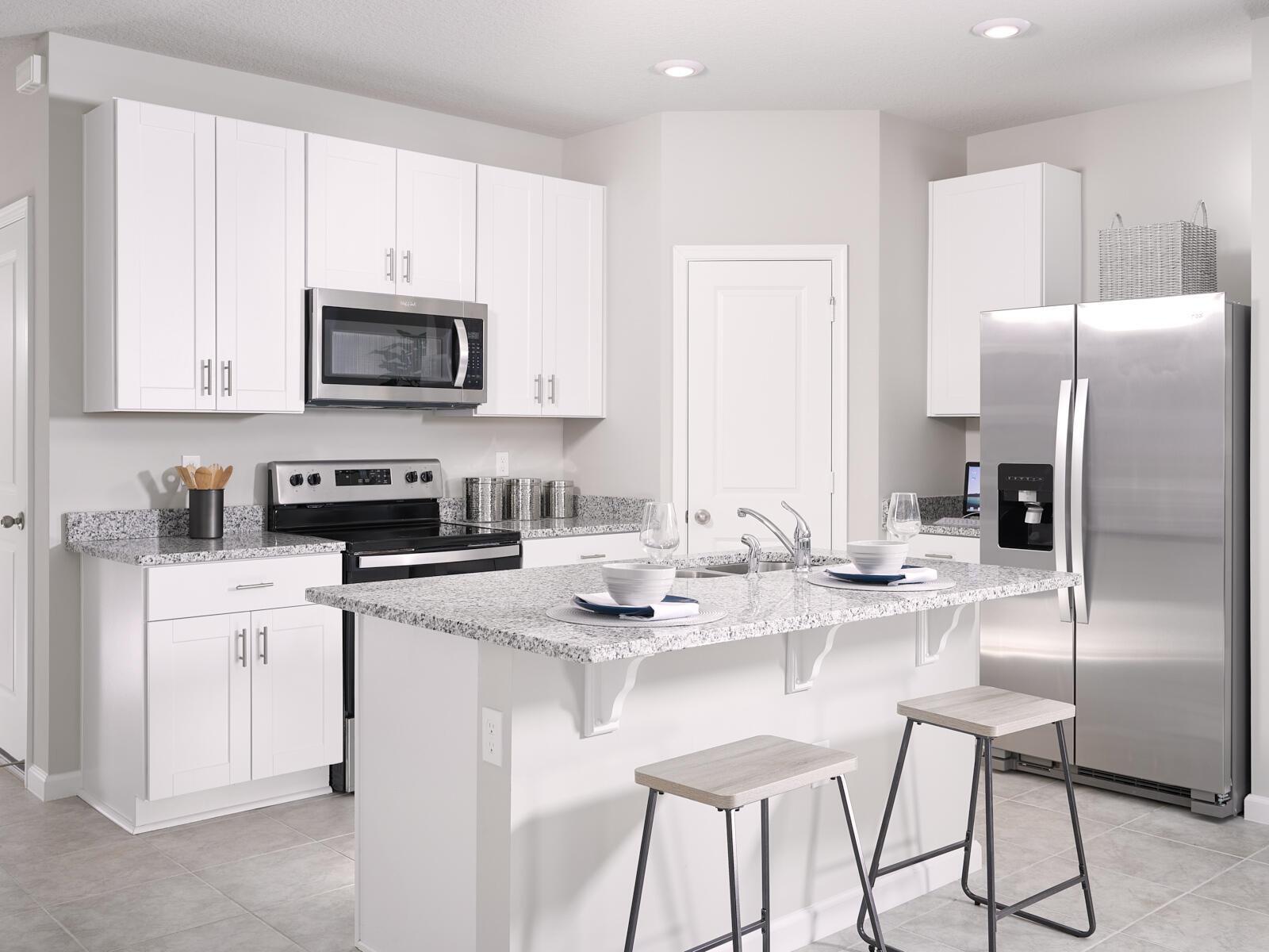 A row of light blue townhouses features paved driveways, white garage doors, and palm trees — 612 Salisbury Circle, Fort Pierce FL 34982, FORT PIERCE, FL