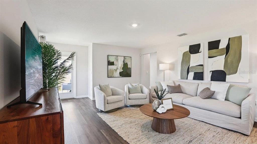 A living room features a sofa, two armchairs, a coffee table, and a television — 3010 VICEROY COURT, POINCIANA, FL