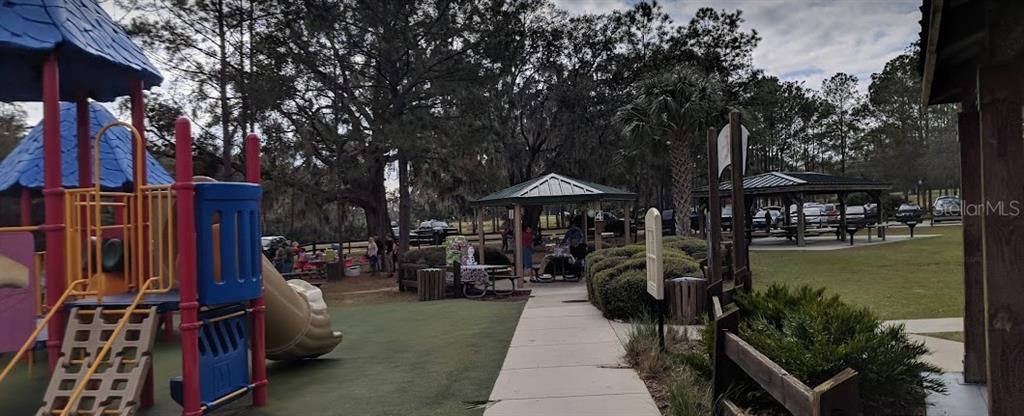 A playground with a slide and climbing structure sits next to a park pavilion — Lot 1 LOCUST PASS COURSE, OCALA, FL