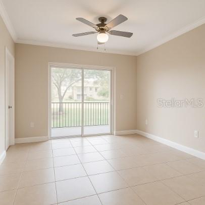 A room with beige tile flooring, a ceiling fan, and sliding glass doors to a balcony — 3701 CASTLE PINES LANE UNIT 3914, ORLANDO, FL