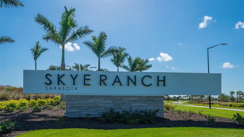 A large, modern sign for Skye Ranch Sarasota stands in a landscaped outdoor area — 8278 VELDA TRAIL, SARASOTA, FL